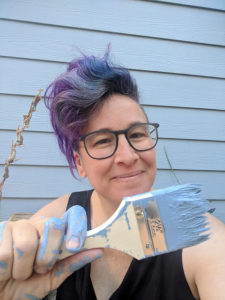liz smiling with a paintbrush